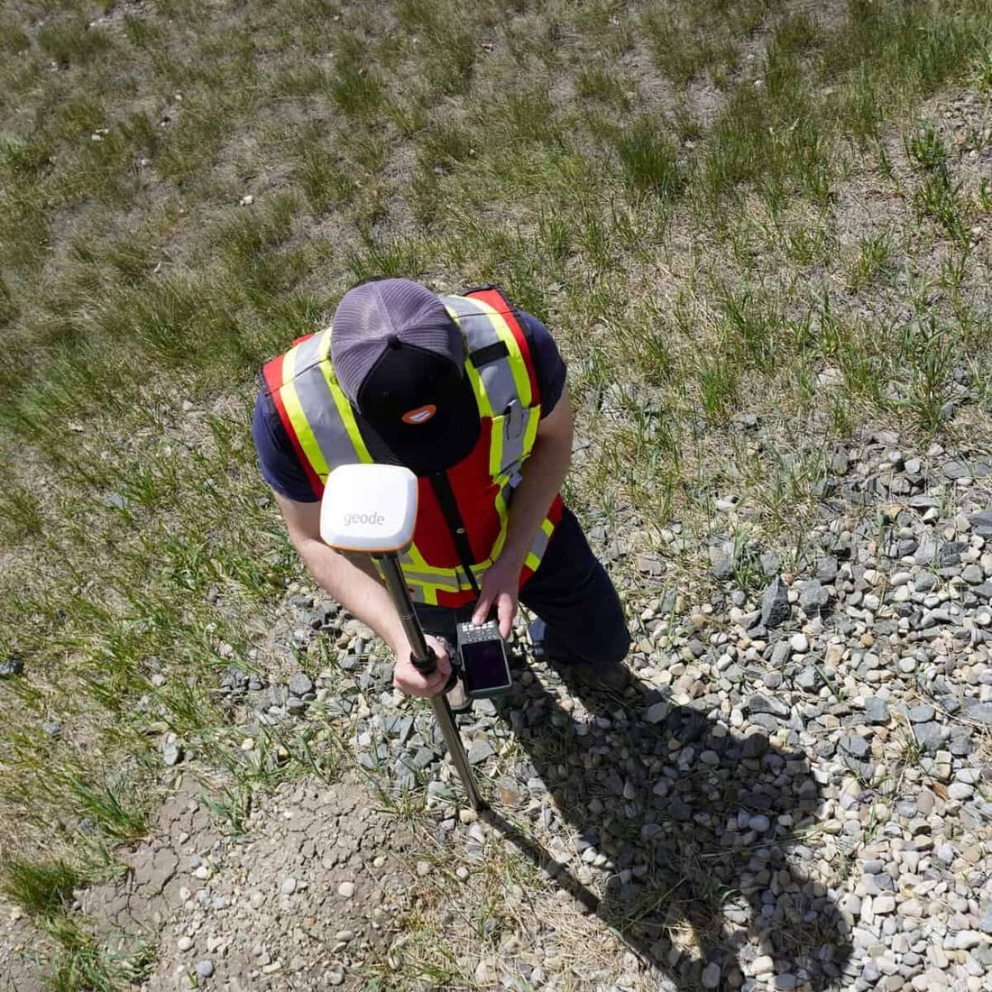 Keaton Greene recording a located utility point with GPS survey equipment