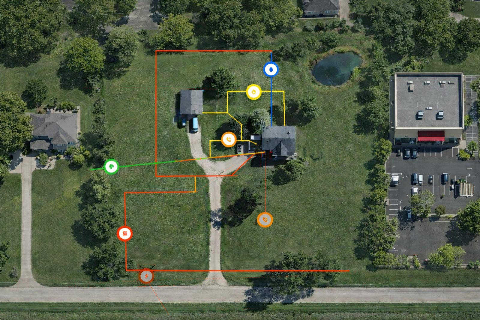 Aerial site map with electric, gas, water, telecom and sewer runs traced in color coded lines